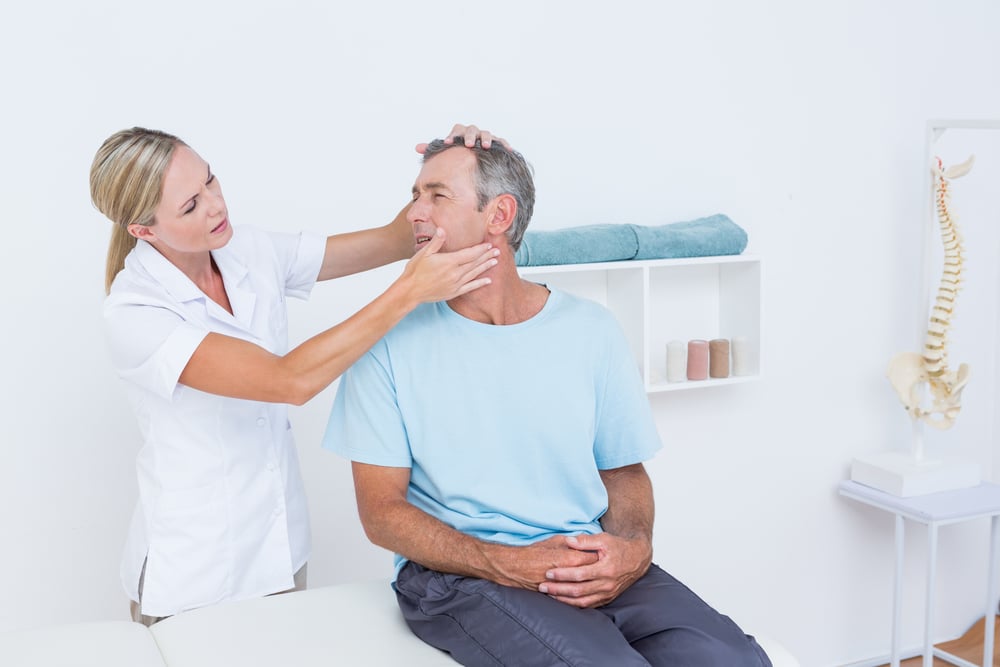 Doctor doing neck adjustment in medical office